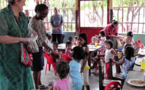 Sarita and Tonia give out toys in Rosa's Kindergarten