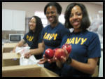 Navy Shipmates bag apples.